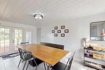 a dining room with a wooden table and chairs at Boat and Fish! Lake Druid Gem with Dog-Friendly Yard in Orlando