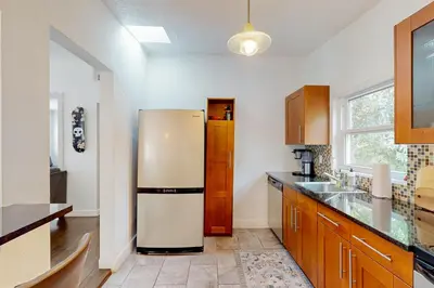 a kitchen with a refrigerator in the middle at Boat and Fish! Lake Druid Gem with Dog-Friendly Yard in Orlando