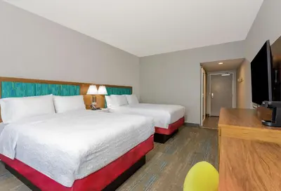 a hotel room with two beds and a television at Hampton Inn By Hilton Ocoee Orlando in Orlando