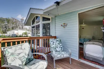 a porch with two chairs and a window at The Hidden Gem Cottage in Kissimmee