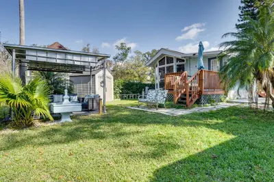 a home with a yard with a house at The Hidden Gem Cottage in Kissimmee