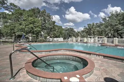 a large swimming pool with a hot tub at The Hidden Gem Cottage in Kissimmee