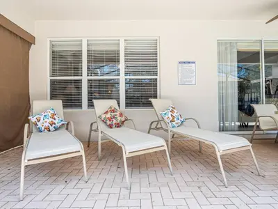 three chairs with pillows in a room with windows at Luxury Disney Villa 5BR With Private Pool and Spa (4 Miles from Disney) in Orlando