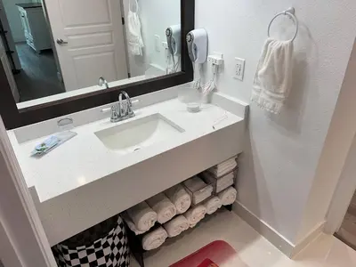 a bathroom with a sink and a mirror and towels at 3 beds DisneyFree Shuttle in Orlando