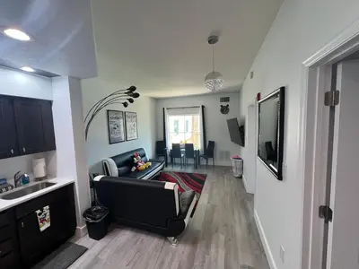 a living room with a couch and a television in it at 3 beds DisneyFree Shuttle in Orlando