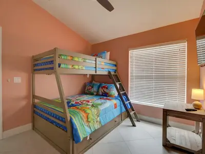 a bedroom with a bunk bed with a ladder at Pool home 5 miles to Disney Great for families in Orlando