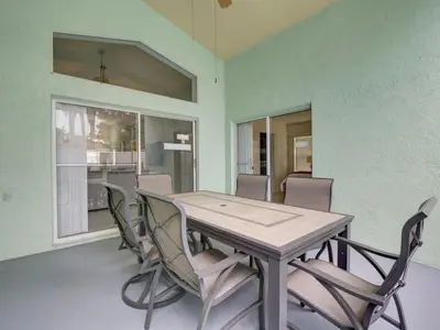 a dining room with a wooden table and chairs at Pool home 5 miles to Disney Great for families in Orlando