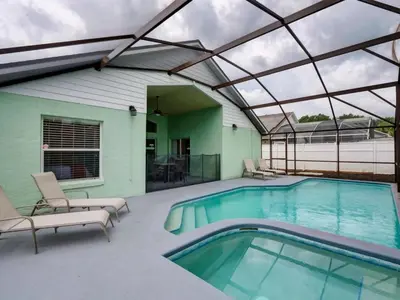 a swimming pool with a glass roof over it at Pool home 5 miles to Disney Great for families in Orlando