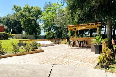 a pavilion with a table and chairs in a garden at Banana Leaf Villa-Island Groove-Standard Suite in Orlando