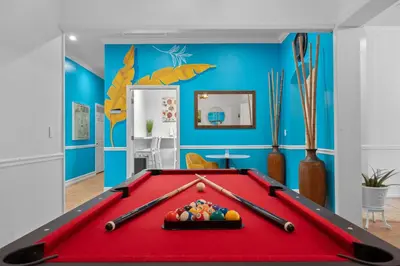 a red pool table in a room with blue walls at Banana Leaf Villa-Island Groove-Standard Suite in Orlando