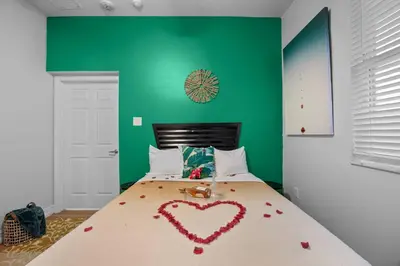 a bedroom with a bed with a heart made out of roses at Banana Leaf Villa-Island Groove-Standard Suite in Orlando