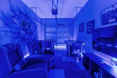 a blue room with couches and a tv at Perfect Disney Getaway House 6BR5BA • Private Pool at Storey Lake Resort SL4788 in Kissimmee