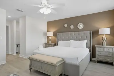 a bedroom with a white bed and a ceiling fan at Perfect Disney Getaway House 6BR5BA • Private Pool at Storey Lake Resort SL4788 in Kissimmee