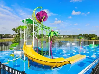 a water park with a slide in a pool at Windsor Hills Townhouse in Orlando