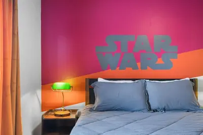 a bed with a star wars sign on the wall at Attention Star Wars fans Amazing 6 BR pool in Kissimmee