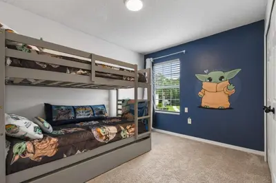 a bedroom with two bunk beds and a blue wall at Attention Star Wars fans Amazing 6 BR pool in Kissimmee