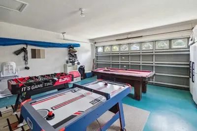 a garage with two pool tables in a room at Indian Ridge- 4 bedroom home with Game Room in Orlando