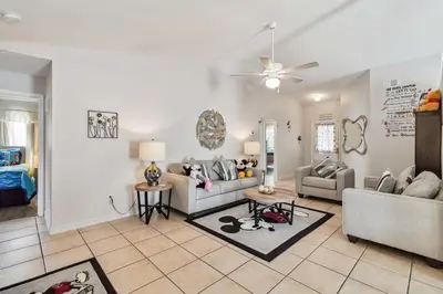 a living room with two couches and a ceiling fan at Indian Ridge- 4 bedroom home with Game Room in Orlando