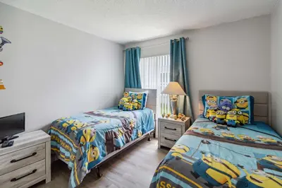 a bedroom with two beds and a tv in it at Indian Ridge- 4 bedroom home with Game Room in Orlando