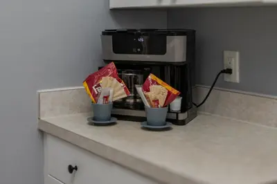 a kitchen counter with two cups on a coffee maker at Star Wars Themed Home at Windsor Palms in Kissimmee