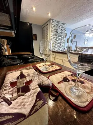 a kitchen with two wine glasses on a counter at Disney's Townhome in Kissimmee