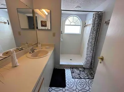 a bathroom with a sink and a shower at Disney's Townhome in Kissimmee