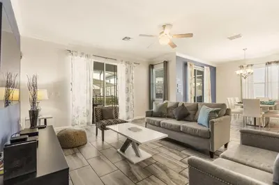 a living room with a couch and a table at Dream Getaway Modern 6-Bedroom Vacation Home in Kissimmee