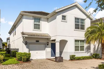 a white house with a garage at Dream Getaway Modern 6-Bedroom Vacation Home in Kissimmee