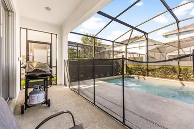 a house with a swimming pool inside of it at Dream Getaway Modern 6-Bedroom Vacation Home in Kissimmee