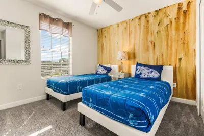 a bedroom with two beds and a wooden wall at Dream Getaway Modern 6-Bedroom Vacation Home in Kissimmee