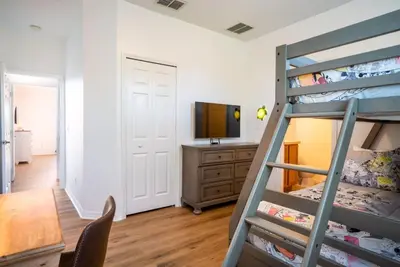 a bedroom with a bunk bed and a television at Disney Retreat Lakeview townhome - close to golf in Orlando