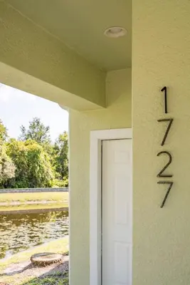 a door to a house with a number on it at Disney Retreat Lakeview townhome - close to golf in Orlando