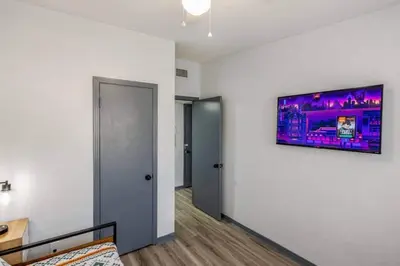 a room with a white wall with a tv on the wall at Magical 3BR Orlando Getaway Kitchen Near Parks in Orlando