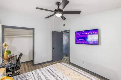 a bedroom with a ceiling fan and a desk at Magical 3BR Orlando Getaway Kitchen Near Parks in Orlando