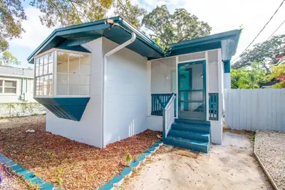 a small white house with a blue roof at Orlando 3BR2BA Family Stay with Big Savings in Orlando