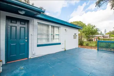 a garage with a blue door and a building at Orlando 3BR2BA Family Stay with Big Savings in Orlando