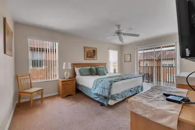 a bedroom with a bed and a ceiling fan at RO2707BD - 4Bedrms - Regal Oaks in Orlando