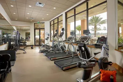 a gym with several treadmills and elliptical machines at RO2707BD - 4Bedrms - Regal Oaks in Orlando