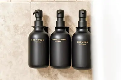 a group of three black bottles on a wall at Trendy Retreat - Great Location - Fully Loaded in Kissimmee