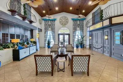 a lobby with a table and chairs in a building at Trendy Retreat - Great Location - Fully Loaded in Kissimmee