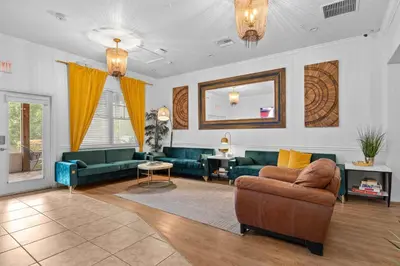 a living room with green couches and a mirror at Banana Leaf Villa-Island groove-Standard room in Orlando