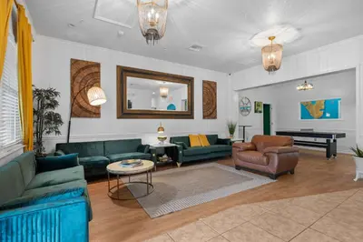 a living room with green couches and a piano at Banana Leaf Villa-Island groove-Standard room in Orlando
