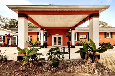 an orange building with a bench in front of it at Banana Leaf Villa-Island groove-Standard room in Orlando