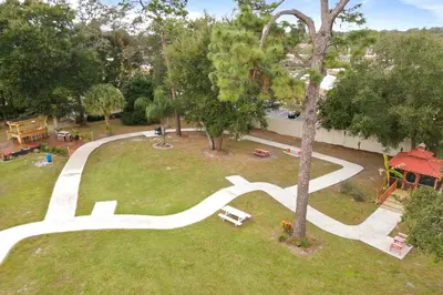 an aerial view of a park with a tree at Banana Leaf Villa-Marley Junior Suite in Orlando