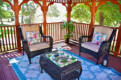 two chairs and a coffee table on a porch at Banana Leaf Villa-Marley Junior Suite with Living Room in Orlando