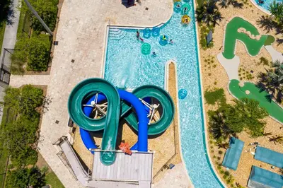 an overhead view of a pool with a water slide at Premium 6BR home w/Pool-BBQ just 10min to Disney in Kissimmee