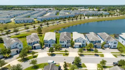 an aerial view of a resort with houses and a lake at Premium 6BR home w/Pool-BBQ just 10min to Disney in Kissimmee