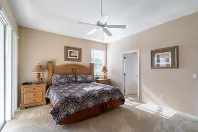 a bedroom with a bed and a ceiling fan at Orlando Renters in Davenport