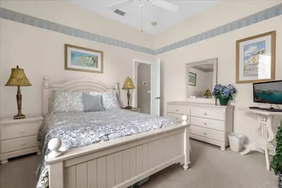 a bedroom with a bed and a desk with a computer at Orlando Renters in Davenport