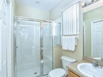 a bathroom with a shower and a toilet and a sink at Orlando Renters in Davenport